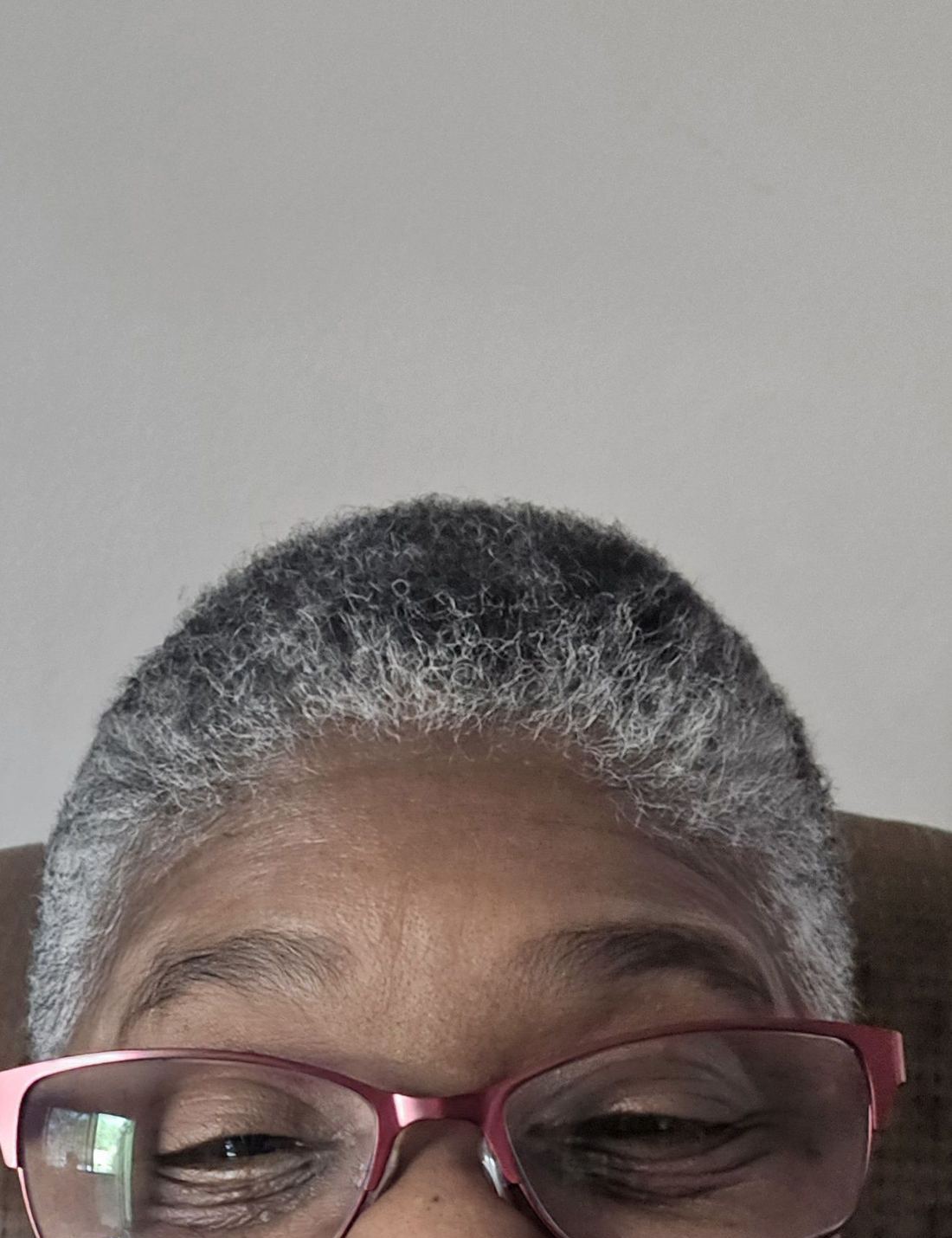 Client smiling with a short, even women's cut